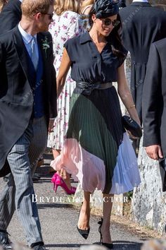 prince harry and his wife, princess charlotte, are seen walking down the street together