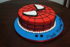 a spiderman birthday cake on a table