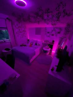 a room with two beds and purple lights on the ceiling is shown in this image