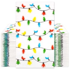 two notebooks with christmas lights on them are lined up next to eachother