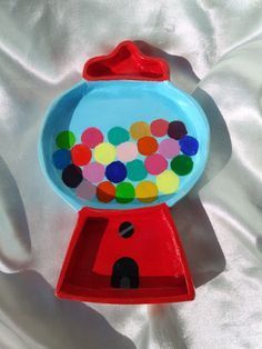 a toy gummy machine sitting on top of a white sheet