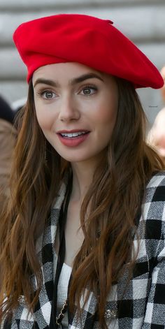 a woman wearing a red beret and smiling