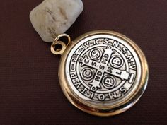 a gold colored pocket watch on a brown surface