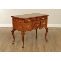 an old wooden table with two drawers on one side and a drawer on the other