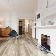 a living room with white walls and wood floors