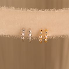 Add a hint of classic charm to your jewelry collection with our Pearl Diamond Huggies ♡ These earrings are your go-to choice when you want to keep it stylish yet relaxed, whether you're running errands or attending a charming wedding! Material: High-Quality Solid 925 Sterling Silver Finish: Sterling Silver ∙ 18K Gold ∙ Rose Gold Hoop Dimensions: ~8 Inner Diameter | ~11mm Outer Diameter Featuring Dainty Huggie Hoop Earrings with ~1.5mm CZ Diamonds and ~2mm Pearls Sold as a Pair Part of our Pearl Elegant Hypoallergenic Cartilage Earrings For Anniversary, Hypoallergenic Elegant Cartilage Earrings For Anniversary, White Cartilage Earrings For Anniversary, Small Hoop Huggie Earrings For Wedding, Gold Cartilage Earrings For Wedding, Elegant Cartilage Earrings For Anniversary, Dainty Silver Huggie Earrings For Wedding, Dainty Tarnish Resistant Huggie Earrings For Wedding, Dainty Tarnish-resistant Huggie Earrings For Wedding