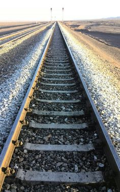 an empty train track in the middle of nowhere