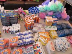 the table is covered with many different types of toothpaste