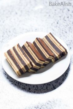 three slices of cake sitting on top of a white plate