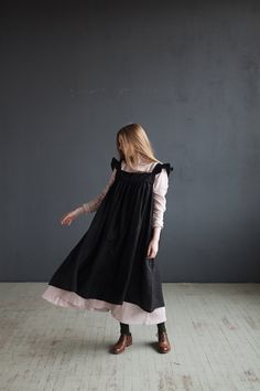 Victorian style inspired pinafore dress with flutter sleeve made from 100% soft and washed Oeko-Tex certified linen Details: - Composition: 100% Oeko-Tex certified linen - Colour: black - Coconut buttons down the back - Size: XS-S, M, L-XL - Medium weight linen - Linen care: machine wash gentle; tumble dry low, ironing optional - The price is for one pinafore dress, other pictured items are not included Black Prairie Dress, Dress With Wings, Linen Pinafore Dress, Moda Kimono, Linen Slip Dress, Wide Leg Linen Trousers, Dress With Flutter Sleeves, Linen Pinafore, Mode Kimono