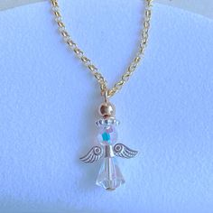 May this sweet angel be a reminder of the presence that is always with you, watching over you from afar. Makes a beautiful gift for someone who may have lost someone special, or simply to tell them they are a godsend in your life! This Sparkly angel is made of Genuine Swarovski Clear AB Crystals and features sterling silver wings and halo! Above the halo is a polished gold bead accent. Please note the angel only comes with sterling silver wings and halo whether you order gold chain or silver cha Spiritual Angel Wings Jewelry For Gifts, Spiritual Angel Wings Necklace As A Gift, White Angel Wings Jewelry As Gift, Spiritual White Charm Necklaces As Gift, Spiritual White Charm Necklace For Gift, White Spiritual Charm Necklaces For Gifts, Angelic White Jewelry For Gifts, Wings And Halo, Lost Someone