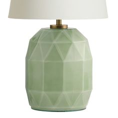 a green table lamp with a white shade