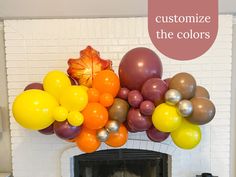 a fireplace decorated with balloons and fall leaves