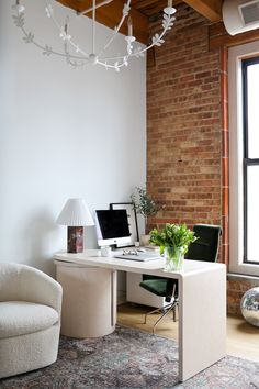 a white desk with a computer on it in front of a window