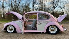 an old pink car with the door open