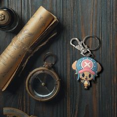 a pirate themed keychain and some other items on a table with a telescope