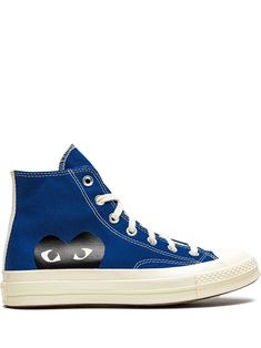 a pair of blue sneakers with an eye patch on the side