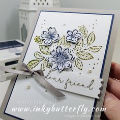 a hand holding a card with flowers on it