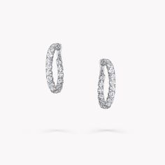 From the Classic Graff collection, our diamond hoop earrings in white gold are a twist on a timeless design. Cradled within a minimal white gold setting, each diamond radiates natural fire and exceptional brilliance. The Classic Graff collection features the finest Graff diamonds showcased in sleek, stylish silhouettes that you will wear time and time again. Available in a variety of different carat sizes. An elegant pair of Classic Graff round diamond hoop earrings with a total approximate weig