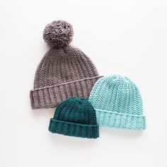 three knitted hats on white background