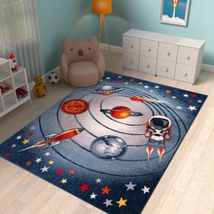 a child's room with blue walls and stars on the floor, including a rug