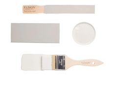 a white paint brush and some other items on a white background