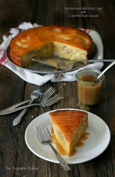 a piece of cheesecake on a plate next to a fork and glass of orange juice