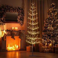 two christmas trees in front of a fireplace with lit candles