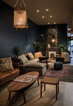 a living room filled with furniture and a fire place in the middle of it's wall