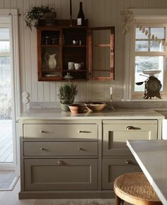 a kitchen with wooden cabinets and white walls