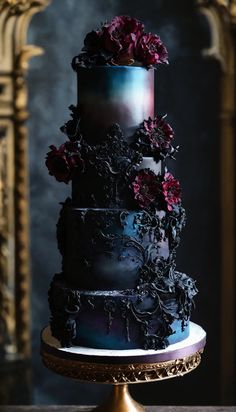 a three tiered black cake with purple flowers on top