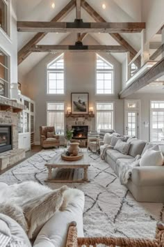 a living room filled with furniture and a fire place in the middle of an open floor plan