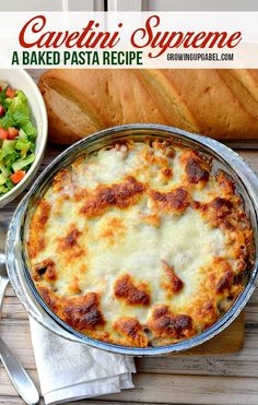 a casserole dish with cheese and meat in it next to a bowl of salad