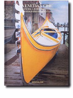 a yellow boat sitting on top of a wooden dock