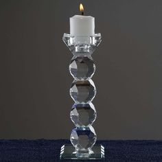 a crystal candle holder with a lit candle