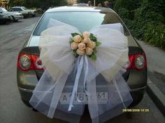 a bouquet of flowers is tied to the back of a car's tailgate