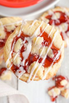 strawberry shortcakes with white icing on a plate