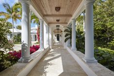 the walkway is lined with columns and flowers