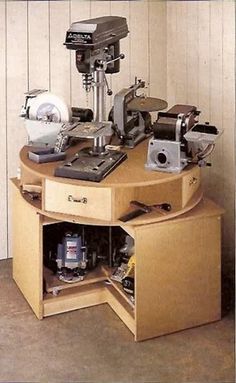 a sewing machine sitting on top of a wooden table next to a drawer filled with tools