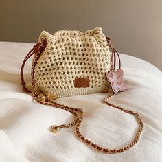 Natural beige colored woven bucket bag. It has a distinctive soft texture, and is accented with a brown leather strap and an elephant charm. Items that will enhance your vacation mood. The atmosphere is casual and relaxed. 
 
 
 Size 
 
 
 FREE size 
 
 Height: 17cm 
 Width: 17cm 
 Depth: 11cm 
 
 
 
 
 
 Material 
 
 Polyester 
 Synthetic leather Colored Weave, Vacation Mood, Elephant Charm, An Elephant, Brown Leather Strap, Summer Knitting, Beautiful Bags, Soft Textures, Bucket Bag