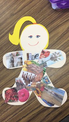 a paper doll with pictures on it sitting on a table