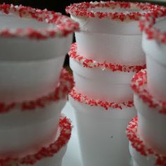 there are many cups that have red and white sprinkles on the top