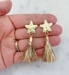 Beautiful star post earrings with a gold tinsel tassel measuring approximately 1.5-2". Perfect as shooting star earrings, 4th of July, Memorial Day, Labor Day, Veterans Day, or any patriotic event! Giftbox included Adjustable Gold Tassel Earrings For Party, Gold Dangle Tassel Earrings, Gold Dangle Tassel Earrings With Fringe, Gold Fringe Tassel Dangle Earrings, Adjustable Gold Tassel Earrings With Fringe, Gift Tassel Drop Earrings With Fringe, Gold Tassel Earrings For Festive Occasions, Fringe Drop Tassel Earrings As Gift, Fringe Tassel Drop Earrings As Gift