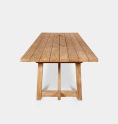 a wooden table sitting on top of a white floor