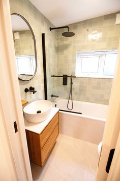 a bathroom with a sink, mirror and bathtub