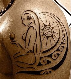 the back of a woman's shoulder with an intricate tattoo design on her arm