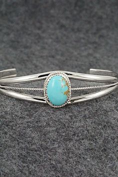 This turquoise and sterling silver bracelet was made by Navajo silversmith Alice Rose Saunders.Size: 5 1/8" (will fit up to a 6 1/2" wrist)Gap: 1 3/8"Width: 5/8"Cuff Width: 1/4"Free shipping on all orders! We ship with USPS and always include tracking. All orders ship within a day of payment.Returns are accepted up to 30 days after you receive your order. Just send us a message. Our shop offers cash back or store credit. The item must be returned in new condition. Classic Turquoise Sterling Silver Bracelets, Adjustable Southwestern Sterling Silver Bracelet With Turquoise, Adjustable Turquoise Sterling Silver Bracelet In Southwestern Style, Adjustable Southwestern Turquoise Sterling Silver Bracelet, Southwestern Style Sterling Silver Bracelet, Classic Turquoise Adjustable Bracelet, Alice Rose, Sterling Silver Bracelet, Turquoise Sterling Silver