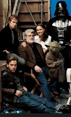 the cast of star wars sit in front of darth vader