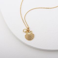 Gold clam shell pendant with tiny pearls inspired by the beautiful ocean world Clams symbolize luck, and give off gentle healing energies, which help in balancing and harmonizing your aura. Please keep the necklace dry and take care in stock after used. Soft and simple. great for gift, everyday or special occasion. Material : Brass, Simulated Pearl Pendant : 13mm x 16mm Pearl : 5mm Ocean-inspired Charm Necklaces As Gift, Ocean-inspired Charm Necklaces As Gifts, Ocean-inspired Charm Necklaces For Gifts, Ocean-inspired Pendant Charm Necklace As Gift, Ocean-inspired Charm Necklace For Gift, Gift Ocean-inspired Shell Necklace With Starfish Charm, Shell Charms Jewelry, Ocean-inspired Shell Necklace With Lobster Clasp For Gift, Starfish Charm Pendant Necklace Gift