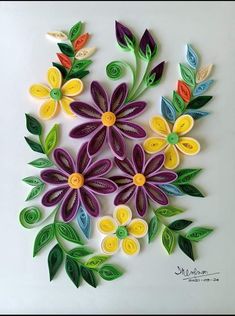 an image of paper flowers with leaves on them